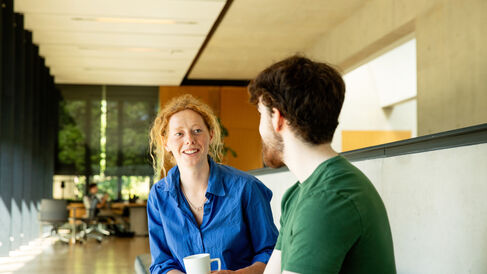 Students talking indoors in quiet area of classroom
