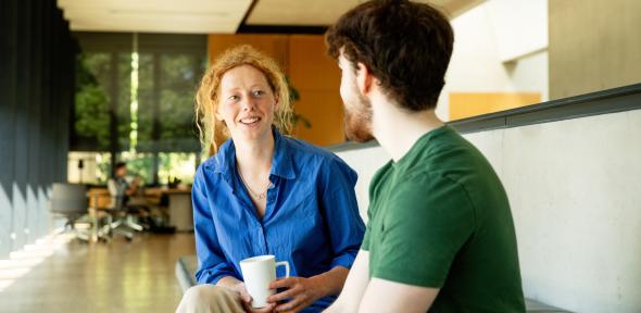Students talking indoors in quiet area of classroom